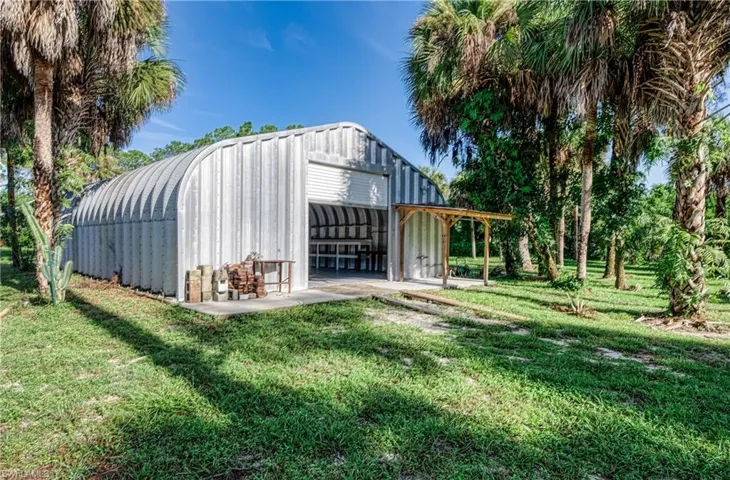 View of outbuilding featuring a lawn