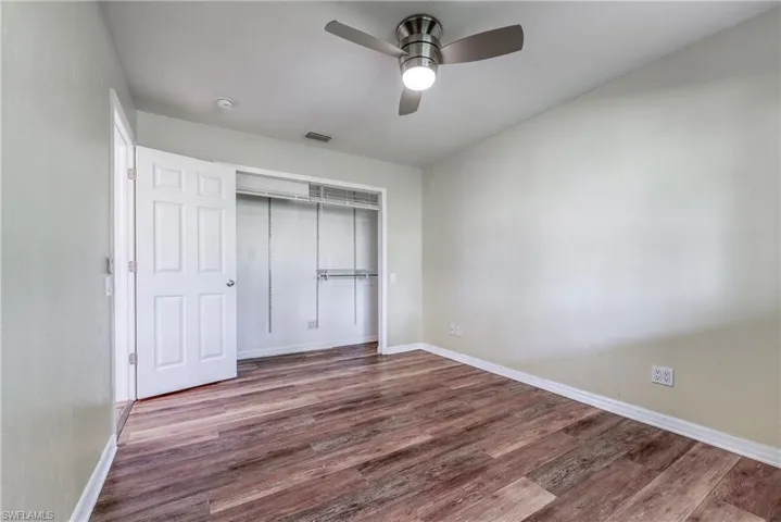 Unfurnished bedroom with a closet, ceiling fan, and hardwood / wood-style flooring