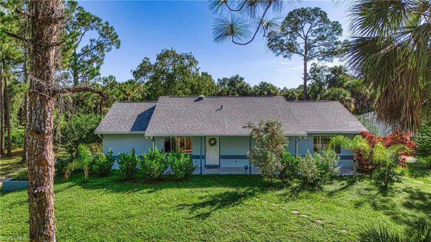 Single story home with a front lawn