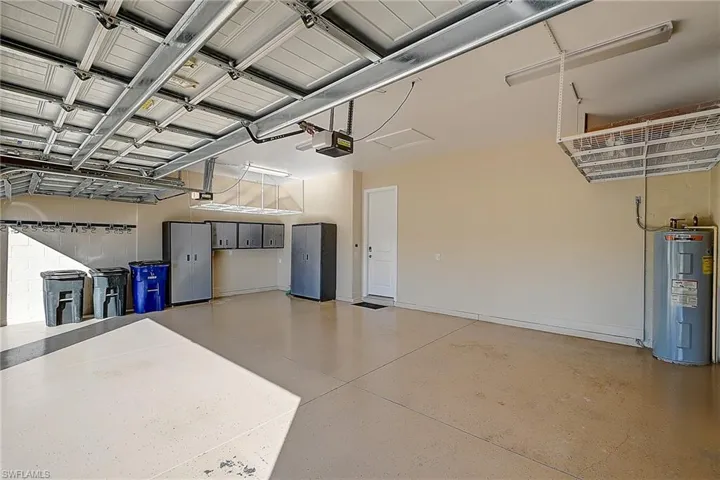 Garage with a garage door opener and electric water heater