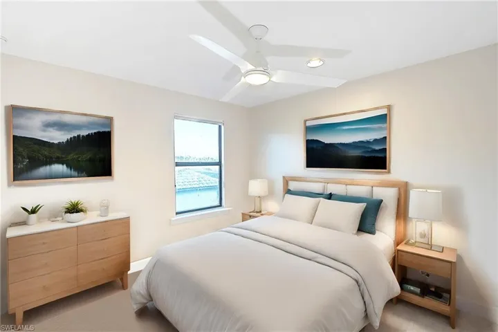 Bedroom featuring light colored carpet and ceiling fan
