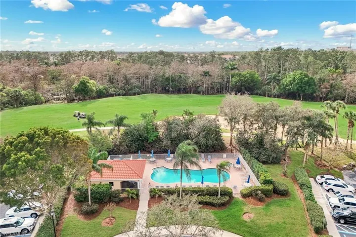 View of pool with a lawn and patio surround