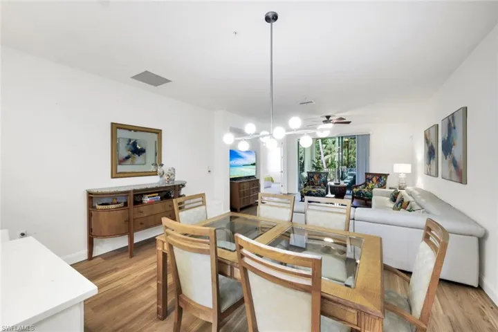 Dining area with light wood-style flooring and ceiling fan