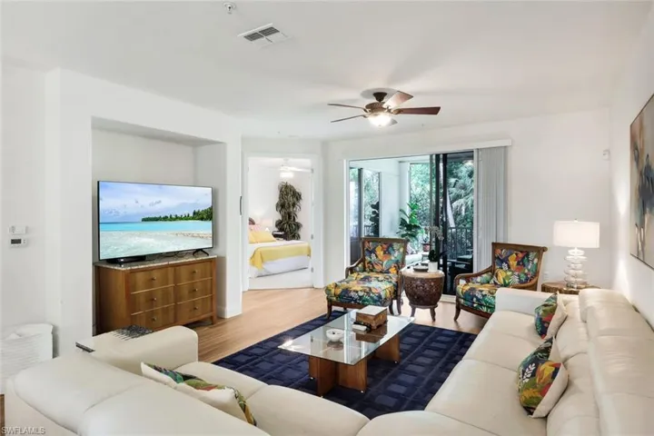 Living area with wood finished floors and a ceiling fan