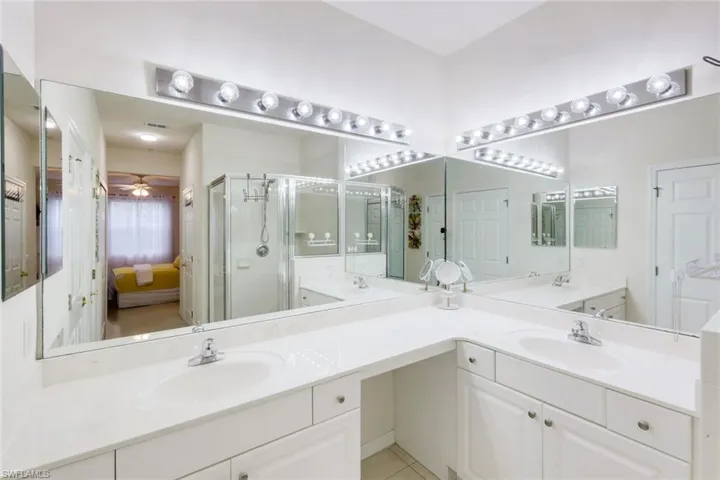 Ensuite bathroom with double vanity and a shower stall