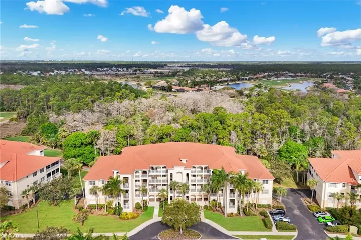 Drone / aerial view of a large body of water and a tree filled landscape