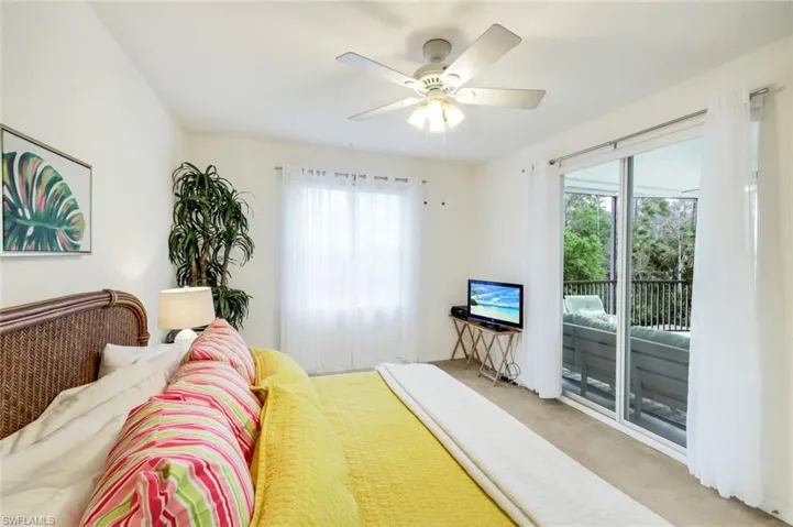 Bedroom featuring carpet, access to outside, and a ceiling fan