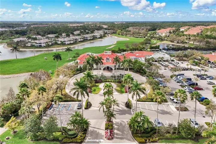 Aerial view of residential area with a nearby body of water and a golf club