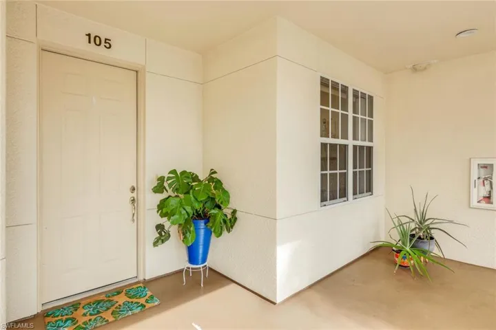 Property entrance featuring stucco siding and a patio area
