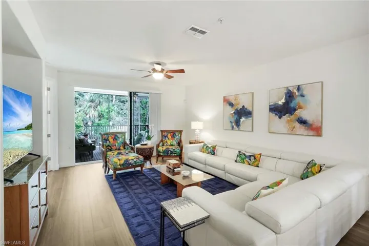 Living room with dark wood-style flooring and ceiling fan