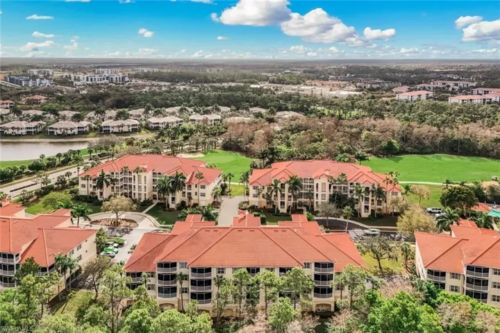 Drone / aerial view of a local golf course and a nearby body of water