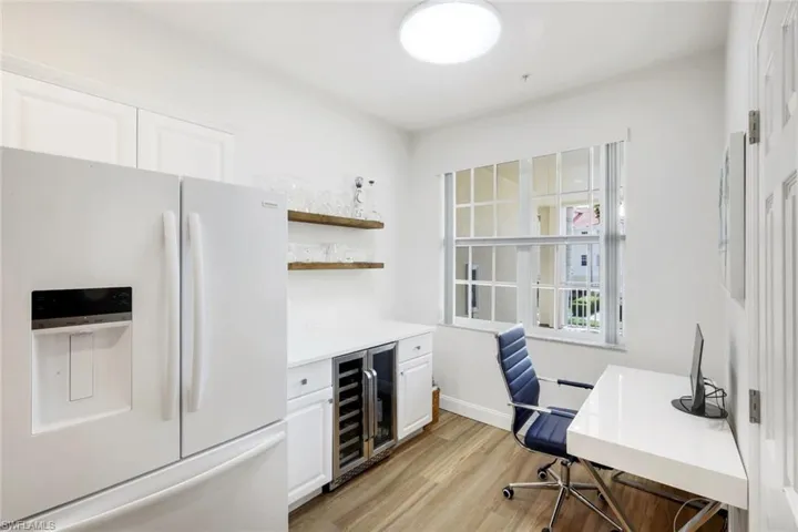 Office space featuring wine cooler and light wood finished floors