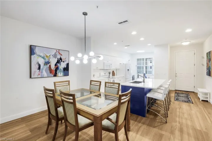 Dining space featuring light wood-style flooring and a chandelier