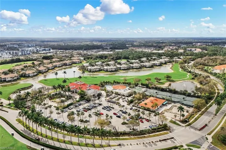 Aerial perspective of suburban area with a golf course and a nearby body of water