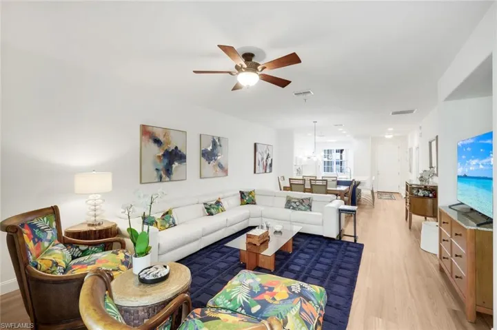 Living area featuring ceiling fan and light wood finished floors