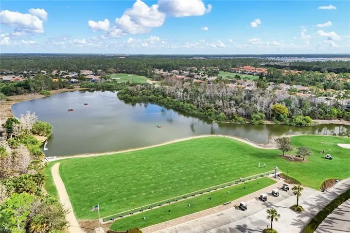 Aerial perspective of suburban area featuring a nearby body of water