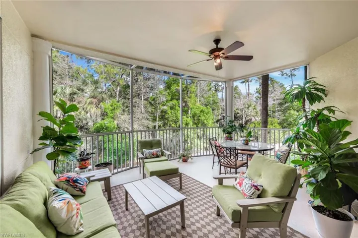 Sunroom / solarium featuring ceiling fan, a patio, and an outdoor living / dining area