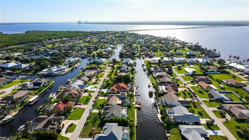 Aerial perspective of suburban area featuring a large body of water