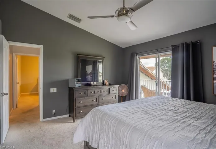 Carpeted bedroom featuring lofted ceiling, access to outside, and ceiling fan