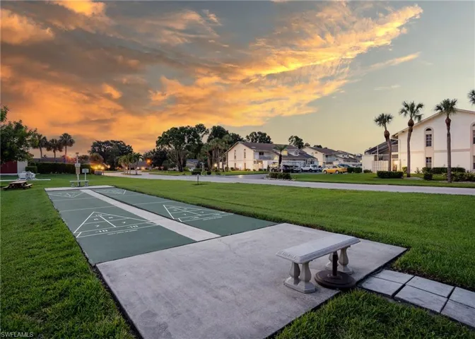 View of home's community with a lawn