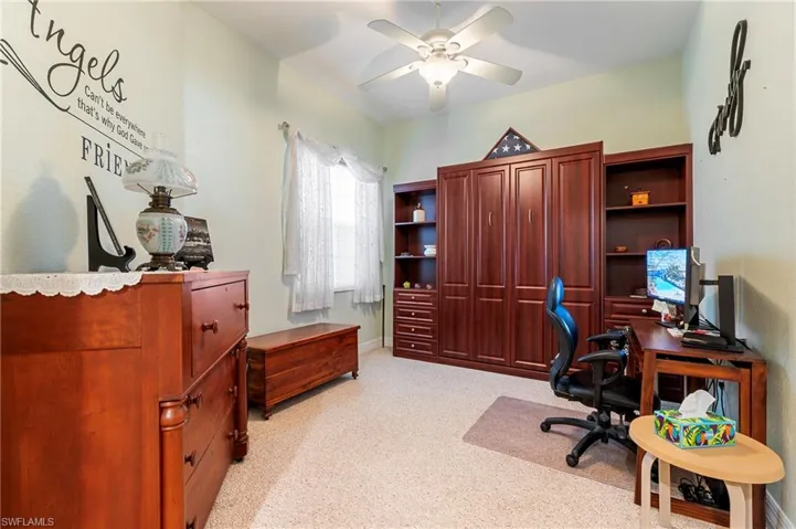 Office space featuring ceiling fan and light colored carpet