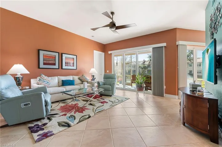 Living area featuring a ceiling fan and light tile patterned floors