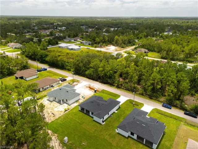 Aerial perspective of suburban area with a heavily wooded area