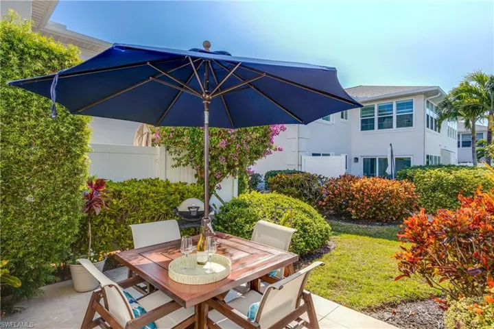 Private patio surrounded by lush landscaping.