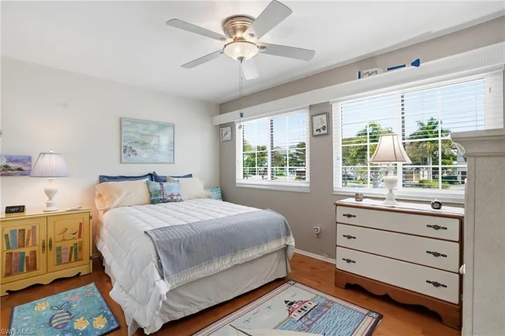 Bedroom featuring wood finished floors and ceiling fan