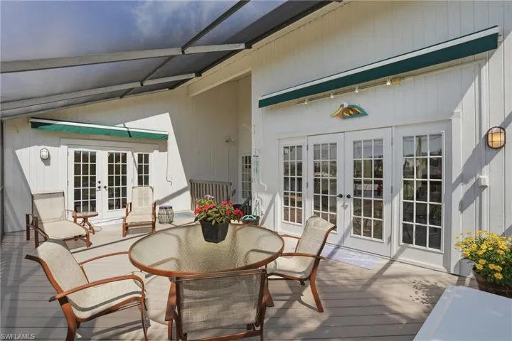 Wooden deck featuring french doors and outdoor dining space