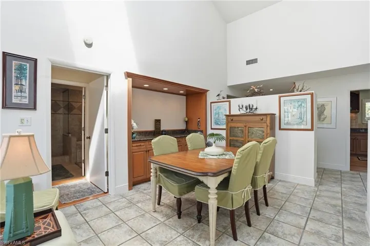 Dining space featuring a high ceiling and light tile patterned floors