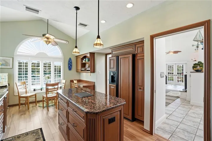 Kitchen with a ceiling fan, wood finish cabinetry, and light wood-style floors