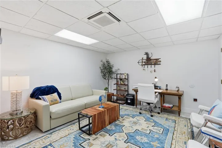 Living area with a paneled ceiling and an office area