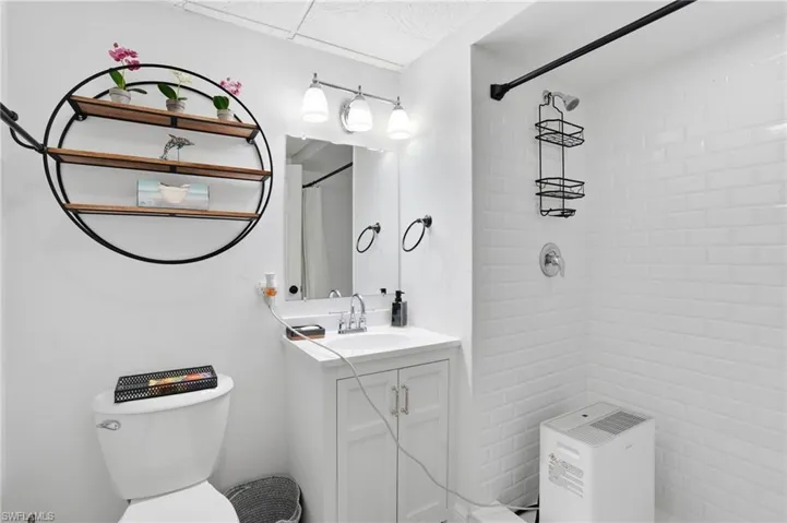 Full bath featuring vanity and a shower