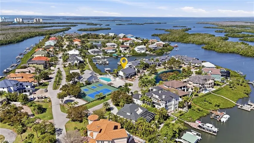 Aerial view of residential area featuring a large body of water