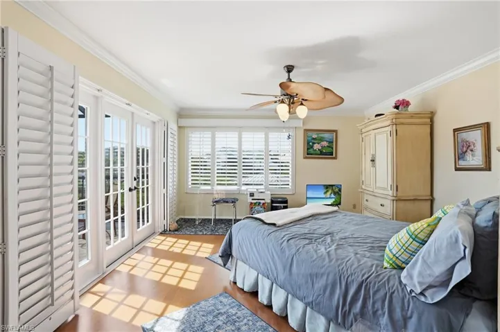 Bedroom featuring french doors, access to outside, crown molding, ceiling fan, and light wood finished floors