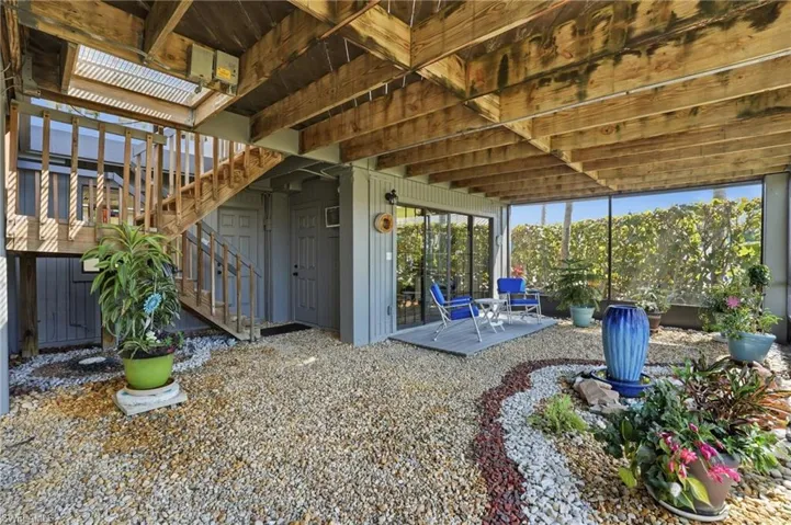 View of patio featuring stairway and a deck
