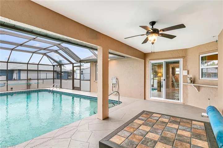 Swimming pool with a lanai, a patio, and a sunroom - Virtually Edited Image