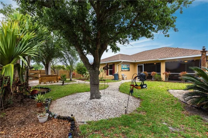View of yard featuring fence and a sunroom