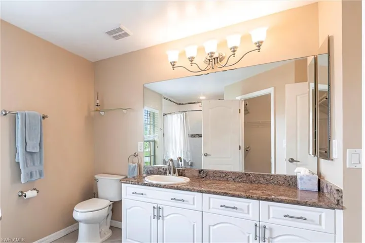 Full bathroom featuring vanity, a shower with curtain and toilet
