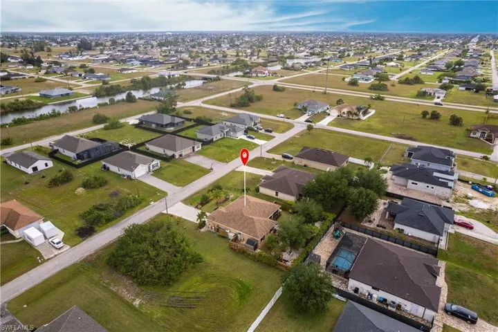 Aerial view featuring a water view and a residential view