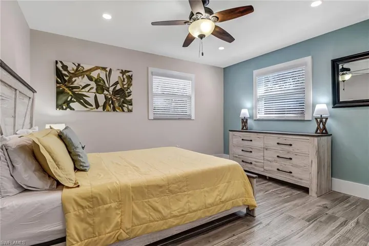 Bedroom featuring wood finished floors, ceiling fan, and recessed lighting