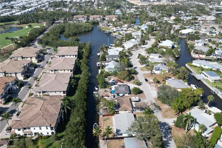 View of property location with a nearby body of water and nearby suburban area