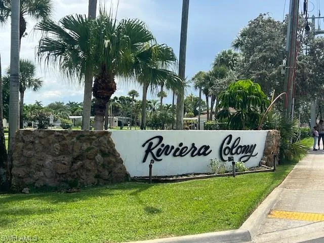 Community sign featuring a lawn