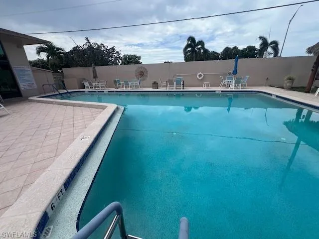 Community pool with a patio