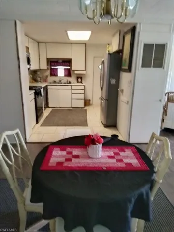 Dining area with a chandelier and light tile patterned floors