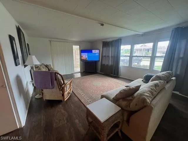 Living area with plenty of natural light and wood finished floors