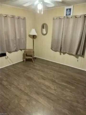 Unfurnished room featuring ceiling fan and wood finished floors