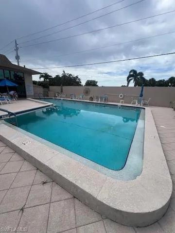 Community pool with a patio