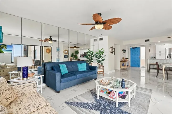 Open-concept living area with tile flooring and a ceiling fan - Virtually Edited Image